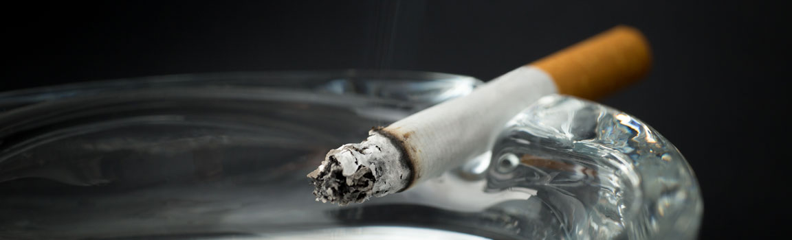 A cigarette is burning on an ashtray